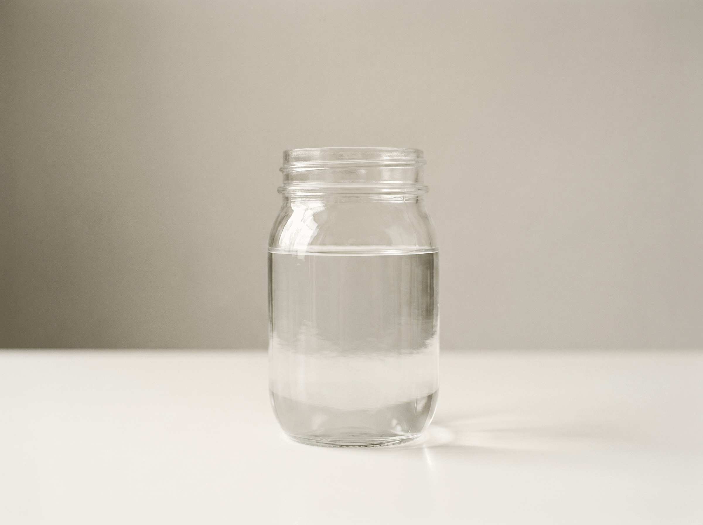 Jar of water poured from the Purestream AquaOne fountain after 48 hours of normal home use — clear and clean.